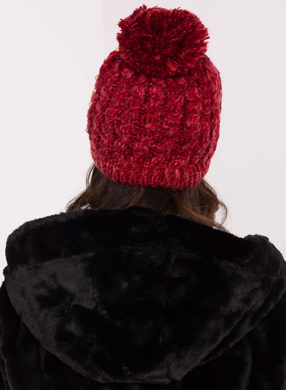 Red padded hat with rhinestones and pompom