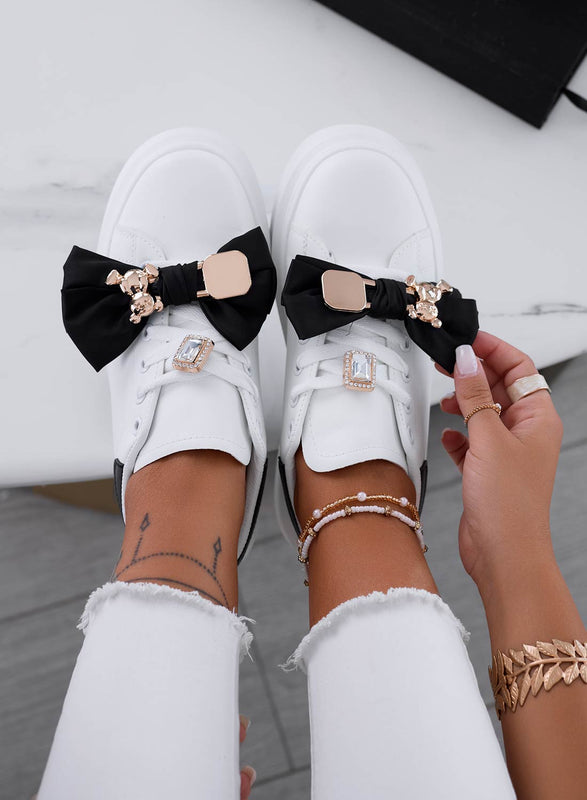 White sneakers with black bow and gold teddy brooch