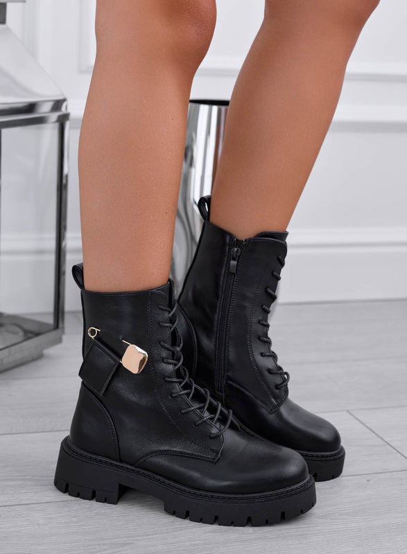 Black ankle boots with gold brooch