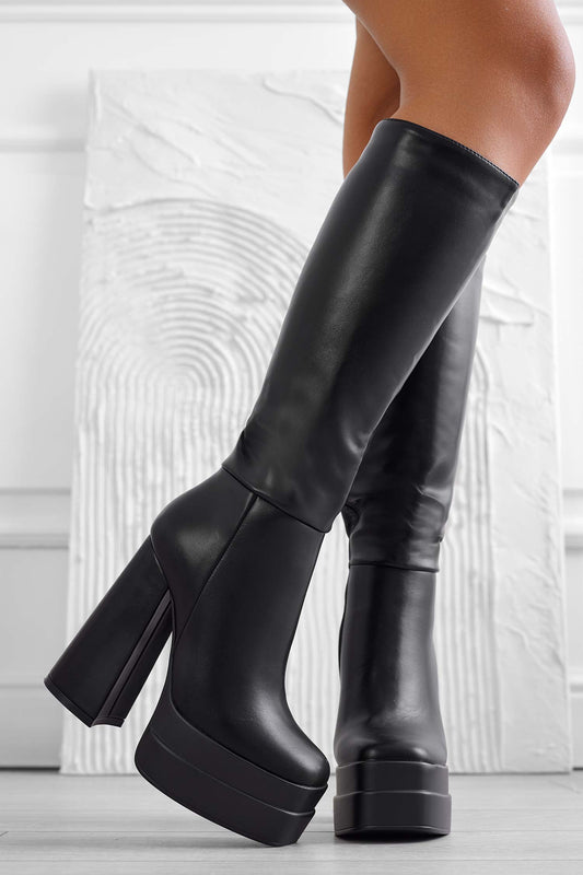 Black faux leather boots with high heel and platform
