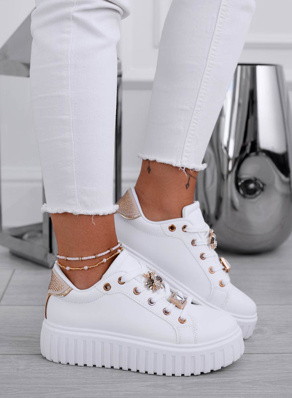 White sneakers with gold bee jewel embellishment
